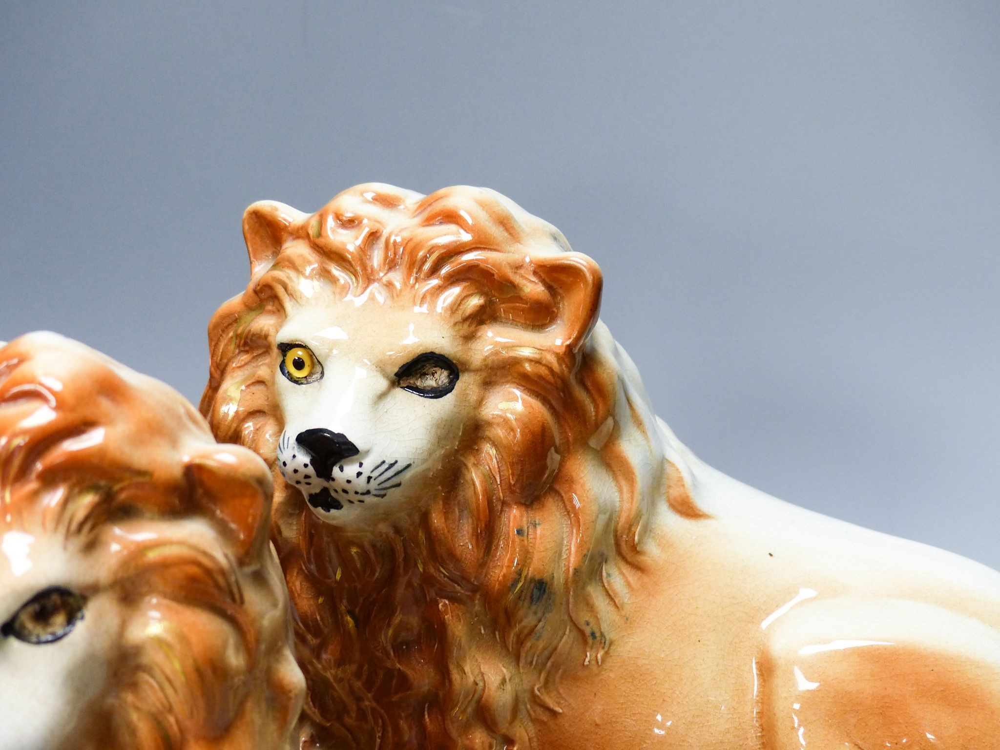 A pair of Staffordshire pottery 'lion' figures 30cm